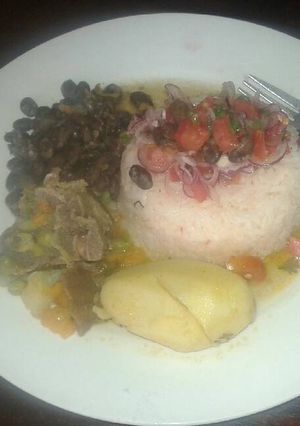 A picture of Fried rice withbeef stew and black beans.