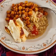 A picture of Honeyed hallloumi on Harissa Tabbouleh with chickpeas tomatoes and yoghurt.