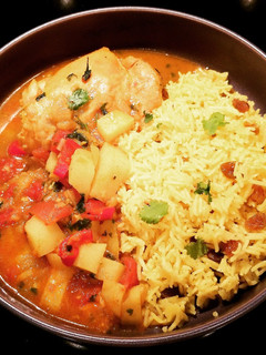 A picture of Cape Malay Chicken Curry with Yellow Rice.