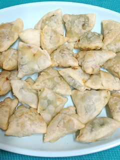 A picture of Pop In The Mouth ----- Mini Spinach & Cheese Samosas with home-made spring roll wrapper.