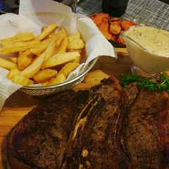 A picture of Mushroom sauce served with steak & chips.