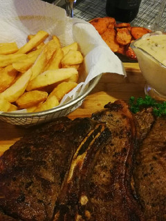 A picture of Mushroom sauce served with steak & chips.