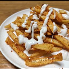 A picture of French fries with mayonnaise.