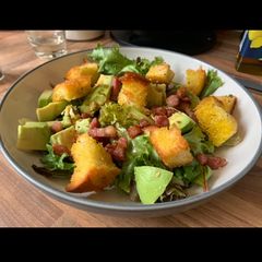 A picture of Warm salad of avocado and bacon with balsamic dressing.