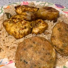 A picture of Chicken roast with kebab and pulao rice.