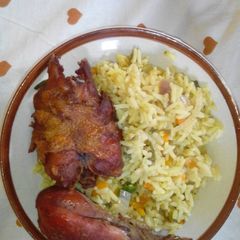A picture of Fried rice and chicken.