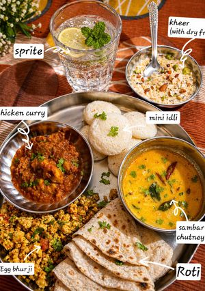 A picture of South Indian Fusion Thali with Chicken Curry & Sweet Kheer Delight.
