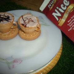 A picture of Chocolate ice cream with edible teacups.