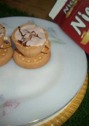 A picture of Chocolate ice cream with edible teacups.