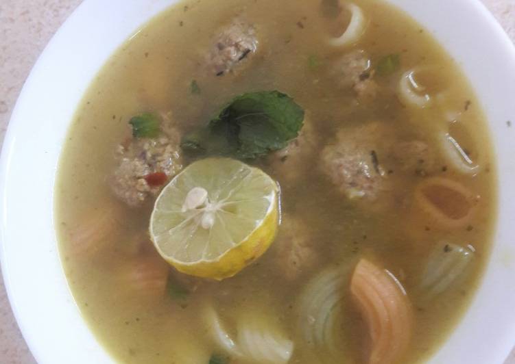 Meatball soup with pasta and herbs