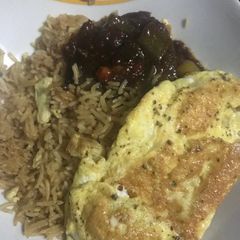 A picture of Concoction Rice with fried egg.