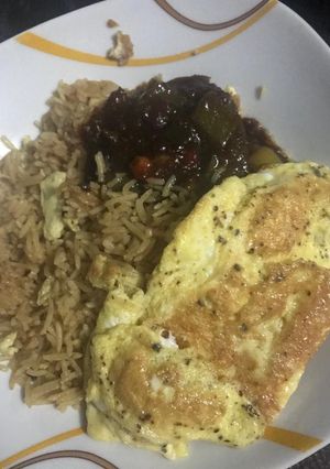 A picture of Concoction Rice with fried egg.