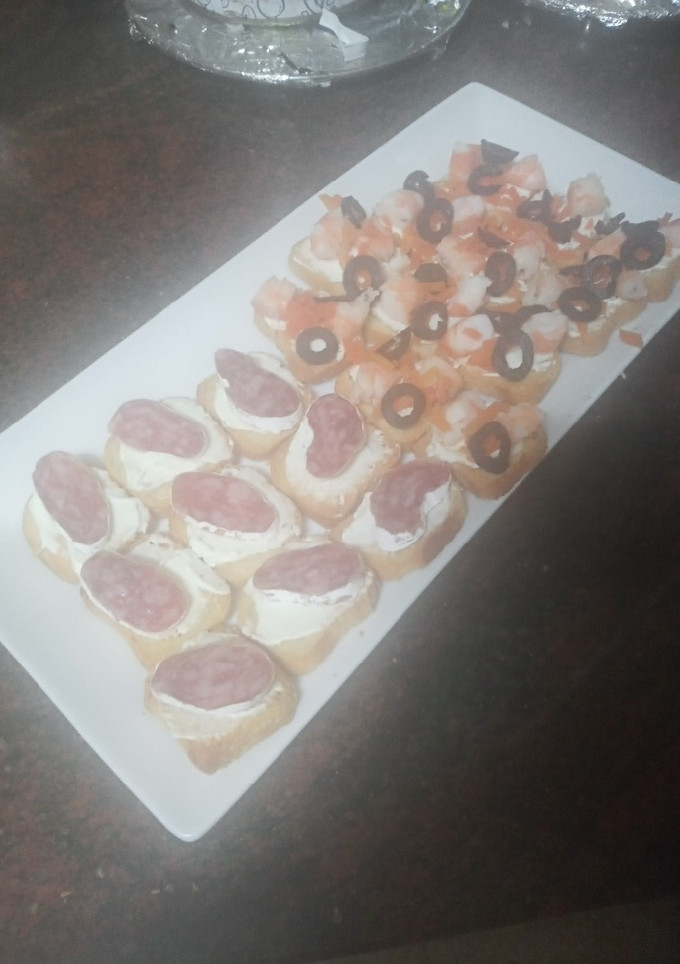 Una foto de Mini bocados variados de queso crema: Langostinos, zanahoria y aceitunas; y Fuet