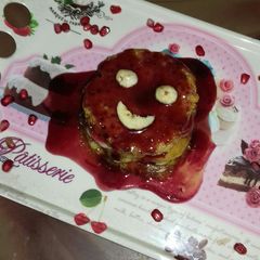 A picture of Banana pancake with pomegranate syrup.