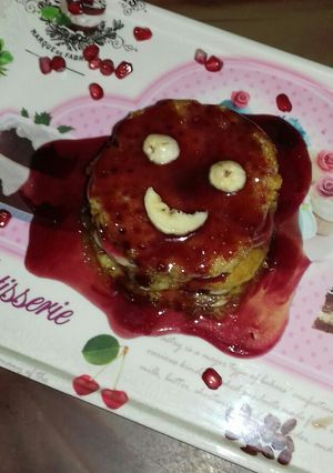 A picture of Banana pancake with pomegranate syrup.
