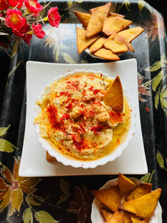 A picture of Nacho chips with hummus.