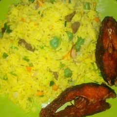 A picture of Fried rice with fried fresh tillapia.