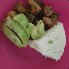 A picture of Pork and Ugali with Spinach.