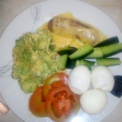 A picture of Boiled eggs with mashed avocado.