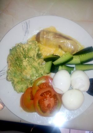 A picture of Boiled eggs with mashed avocado.