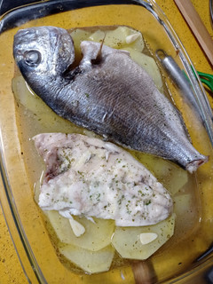 Una foto de Dorada al horno con patatas