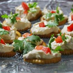 A picture of Monaco biscuit with a yoghurt cheesy topping.