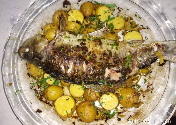 Baked whole fish with lemon and potato recipe main photo