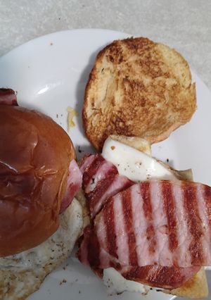 A picture of Grilled Bacon, Potato Scone and Fried Egg Bap.