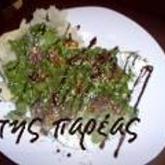 A picture of Arugula with caramelised figs in a parmesan nest.