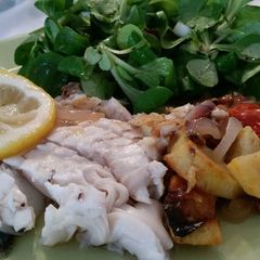 A picture of Fish with roasted vegetables.