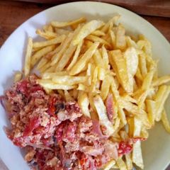 A picture of Chips and eggs for breakfast so delicious.