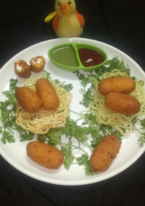 A picture of #monsoon_Paneer -potato rolls in noodles nests.