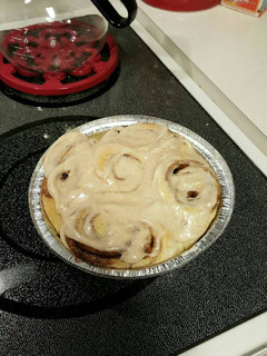 A picture of TL'S pudding Cinnamon Rolls with cream cheese.