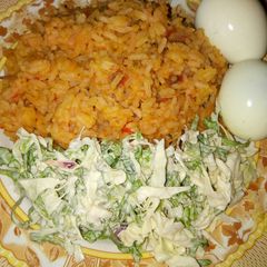 A picture of Jollop rice and salad with eggs.