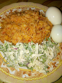 A picture of Jollop rice and salad with eggs.