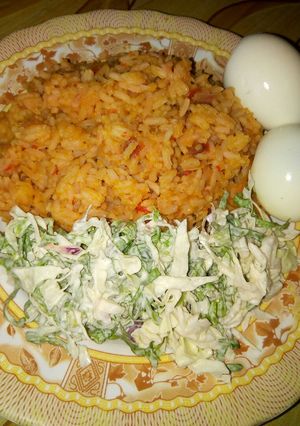 A picture of Jollop rice and salad with eggs.