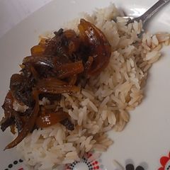 A picture of White rice with onion and minced meat sauce.