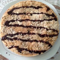 A picture of No butter coffee cake with chocolate drizzle and pumpkin seeds.