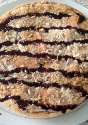 A picture of No butter coffee cake with chocolate drizzle and pumpkin seeds.
