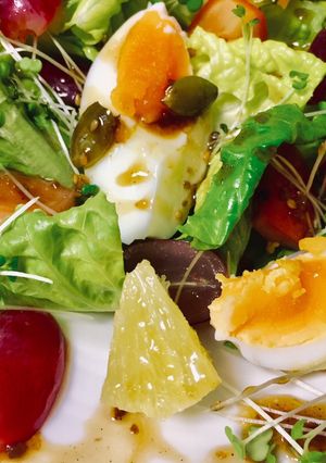 A picture of Boiled Egg Baby Greens and Fruit Salad.