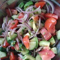 A picture of Cucumber tomato avocado salad.