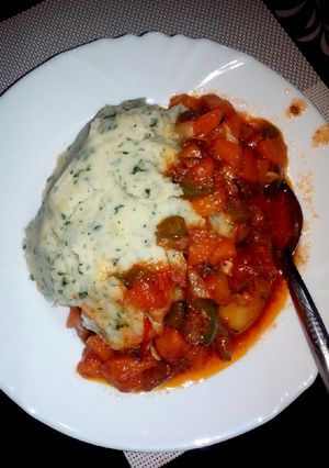 A picture of Mashed potatoes with vegie meat stew.