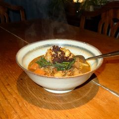 A picture of Puy lentil stew with baked cauliflower and steamed cavolo nero.