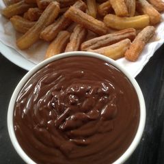 A picture of Churros and chocolate dip.