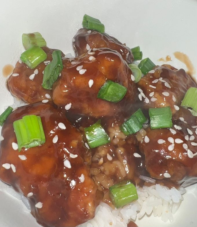 A picture of Orange Chicken with White Rice.