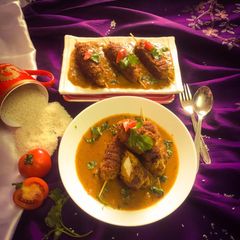A picture of Chickpea stuffed kebab in roasted gravy.