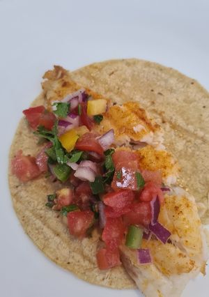 A picture of Fish Tacos with Paprika and Pico de Gallo.