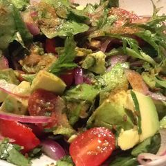 A picture of Mexican avocado salad w tomato, lime, toasted cumin.