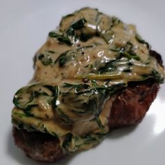 A picture of Steak with gorgonzola and spinach.