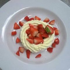 A picture of Meringue nests, with Chantilly cream and strawberries.